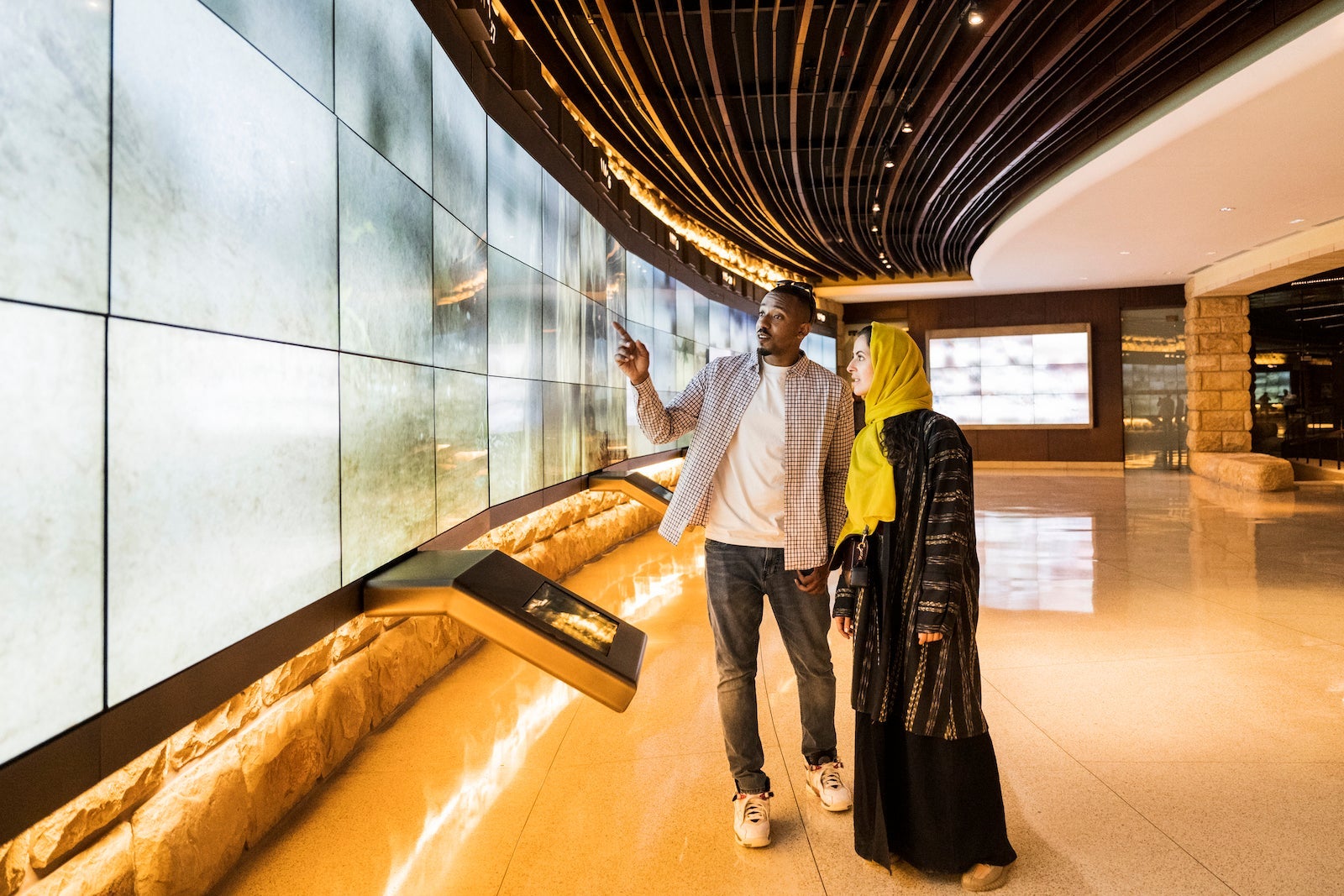 Couple checking out digital museum display